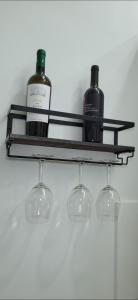 a shelf with two bottles and glasses on it at Renova7io sweet home Napoli in Naples
