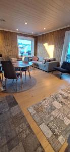 a living room with a couch and a table at Sentral leilighet på Geilo in Geilo +42 photos