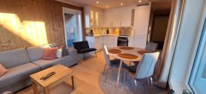 a living room with a couch and a table at Sentral leilighet på Geilo in Geilo