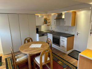 a small kitchen with a wooden table and a table and chairs at Ferienwohnung Im Einklang in Buchen