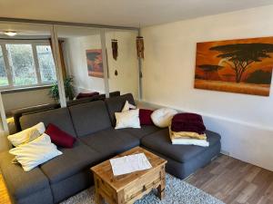 a living room with a couch and a table at Ferienwohnung Im Einklang in Buchen