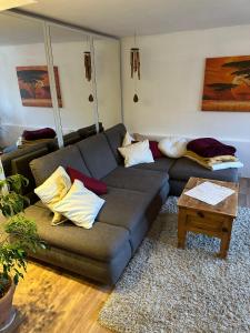 a living room with a couch and a table at Ferienwohnung Im Einklang in Buchen