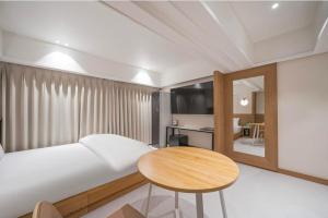 a living room with a white couch and a table at 9AVENUE hotel in Daegu +1 photo