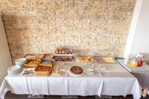 a table with many different types of bread and pastries at Nauticus Hotel Ugento in Torre San Giovanni Ugento
