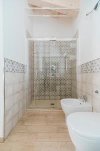 a bathroom with a shower and a toilet and a sink at Il Conventino 46 in Falconara Marittima