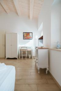 a bedroom with a bed and a desk and a table at Il Conventino 46 in Falconara Marittima