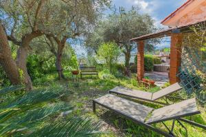 a backyard with a bench and a house at Ca du Aldo - La Crema in Finale Ligure