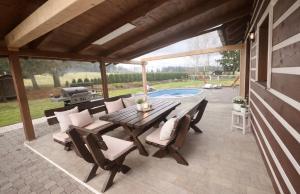 a patio with a table and chairs and a pool at Chaloupka v ráji in Veselá