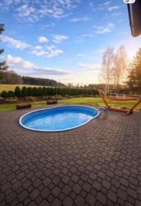 a small pool in a yard with a patio at Chaloupka v ráji in Veselá +7 photos