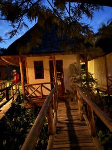 a small house with a wooden pathway leading to it at Sunscape lodge in Fort Portal +7 photos
