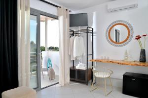 a white room with a mirror and a chair at SunDay Free Airport Shuttle in Artemida