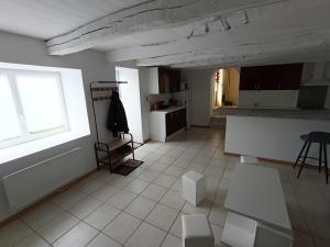 a kitchen with a large window and a white tile floor at Gîte ô scope-2km du futuroscope- linges et ménage inclus in Jaunay-Clan