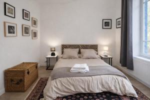 a bedroom with a large bed and two tables at Creil Sud, près de l'Oise in Creil