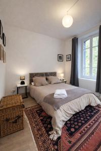 a bedroom with a large bed and a large window at Creil Sud, près de l'Oise in Creil
