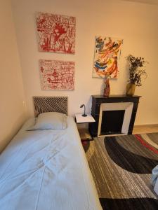 a bedroom with a bed and a fireplace at Creil Sud, près de l'Oise in Creil +14 photos