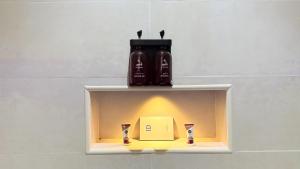 a shelf with two bottles and a box on it at سديم الفخر 2 للشقق الفندقية in Taif +87 photos
