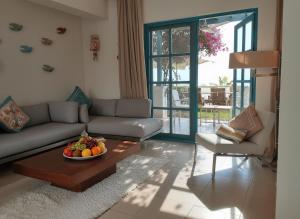 a living room with a couch and a bowl of fruit on a table at Unique cozy villa sea view in Hurghada
