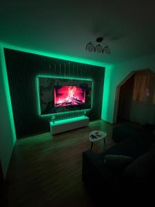 a living room with a fireplace with green lights at Apartament Eric in Mangalia