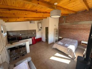 a bedroom with a bed and a brick wall at Laguna de los Cisnes in Perito Moreno