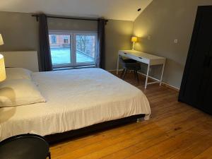 a bedroom with a bed and a desk and a window at Brussels EU District Mansion in Brussels