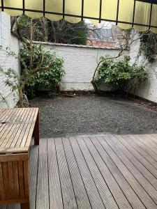 a wooden bench sitting on top of a wooden deck at Brussels EU District Mansion in Brussels