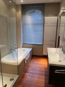 a bathroom with a tub and a sink at Brussels EU District Mansion in Brussels +22 photos