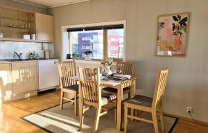 a kitchen with a table and chairs in a kitchen at Nordic Comfort Apartment in Trondheim