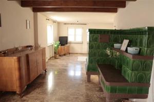 a living room with a green couch and a sink at Zurück zur Wurzel in Karsau +11 photos