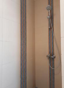 a shower with a shower head in a bathroom at Unique cozy villa sea view in Hurghada +9 photos