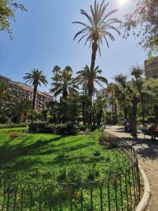 a park with palm trees and a fence at Il Nido della Gioia Affittacamere in Trani