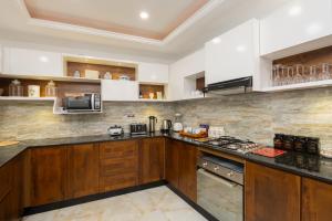 a kitchen with wooden cabinets and a counter top at Lasantha's Residence in Kadawata