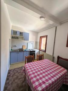 a kitchen with a table and chairs in a room at Apartmani Vita in Divčibare