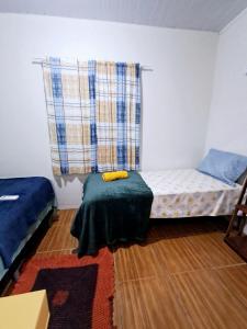 a room with a bed and a window with a couch at aguapé 1 in Barreirinhas