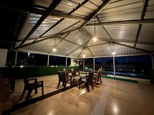a patio with a table and chairs on a roof at Vedanta Retreat in Igatpuri