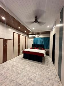 a bedroom with a bed and a blue curtain at Vedanta Retreat in Igatpuri