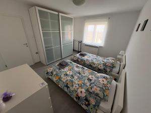 a small bedroom with two beds and a table at Apartma S in Sežana