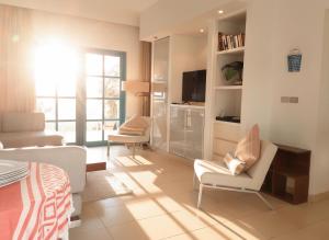 a living room with a couch and chairs and a television at Unique cozy villa sea view in Hurghada