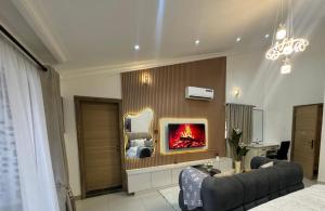 a living room with a couch and a fireplace at ShowLove Luxury Apartment in Lekki Phase 1
