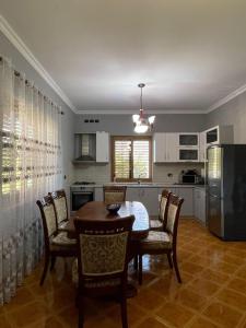 a kitchen and dining room with a table and chairs at VillaSolmare Velipoje in Velipojë