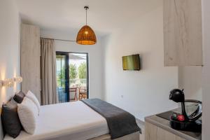 a bedroom with a bed and a balcony at Aethrèa Apartments in Haraki