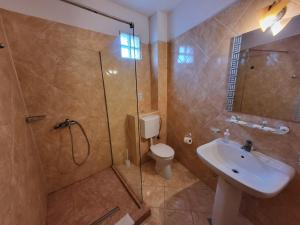 a bathroom with a shower and a toilet and a sink at Vila Casa Esy in Eforie Nord +76 photos