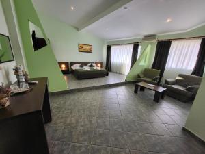 a large living room with green walls and a couch at Vila Casa Esy in Eforie Nord