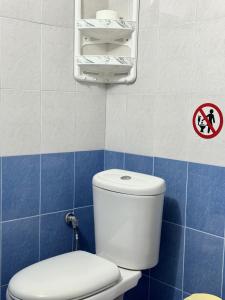 a bathroom with a white toilet in a blue tiled wall at Villa Mare Blue in Ksamil