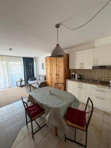 a kitchen and dining room with a table and chairs at Ferienwohnung Voges in Bad Lauterberg