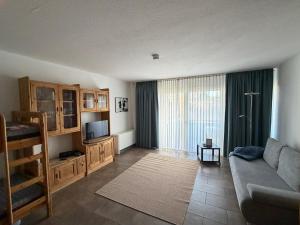a living room with a couch and a television at Ferienwohnung Voges in Bad Lauterberg