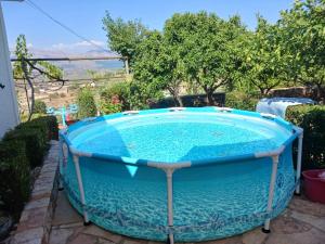 a hot tub in the backyard of a house at Family PlayHouse - Villa Mitsi Sarande in Sarandë