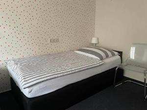 a bed in a bedroom with a polka dot wall at Ferienwohnung Lukas in Frielendorf +5 photos