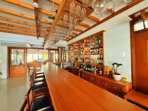 a bar with a long wooden table and chairs at The Horse Farm Hotel in Kyrenia