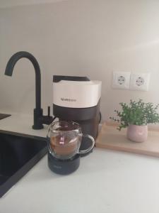 a kitchen counter with a coffee maker and a blender at Ventalia in Kimolos