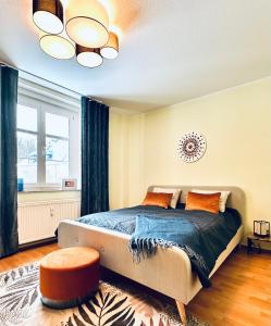 a bedroom with a bed and a large window at KÜCHWALDBLICK Designsuite in Chemnitz